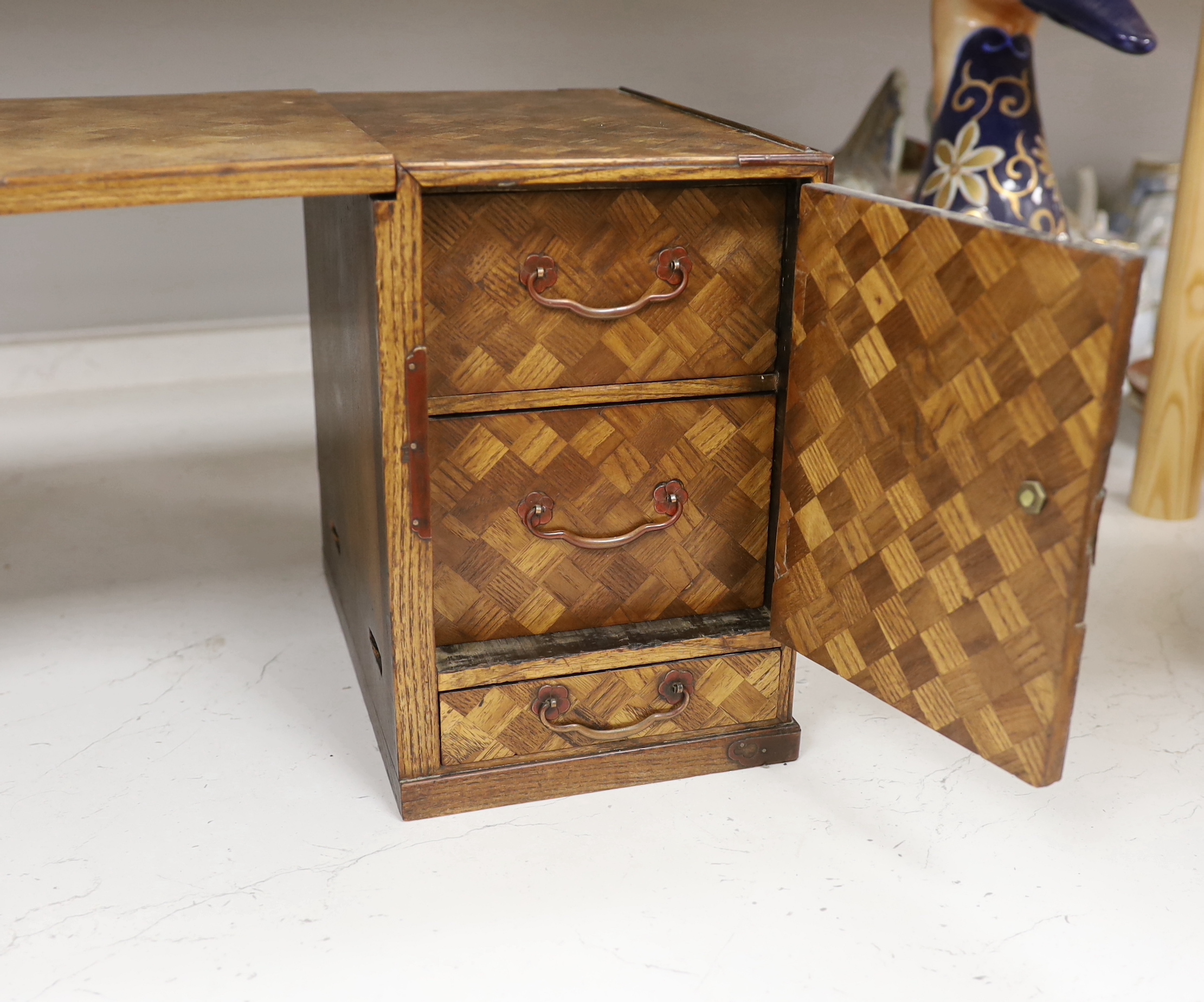 An early 20th century Japanese parquetry table cabinet or scholar's box, 24.5cm high, 63cm wide when extended